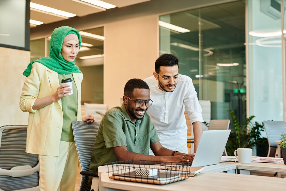 A diverse group of colleagues collaborating in a bright, modern office space.